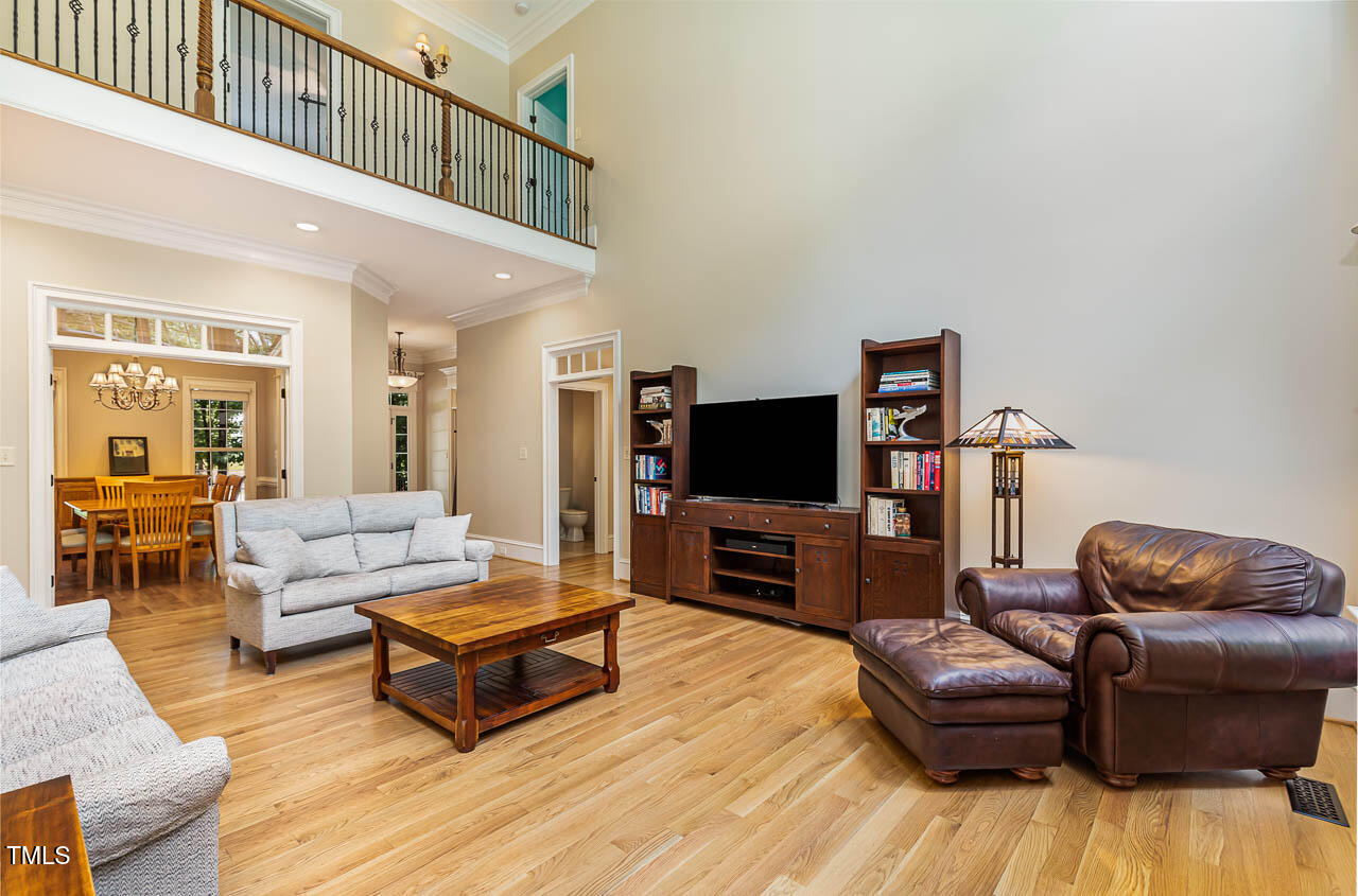 1097 Tacketts Pond Drive Raleigh, NC 27614 - Photo 10 of 38 a living room with furniture and a flat screen tv