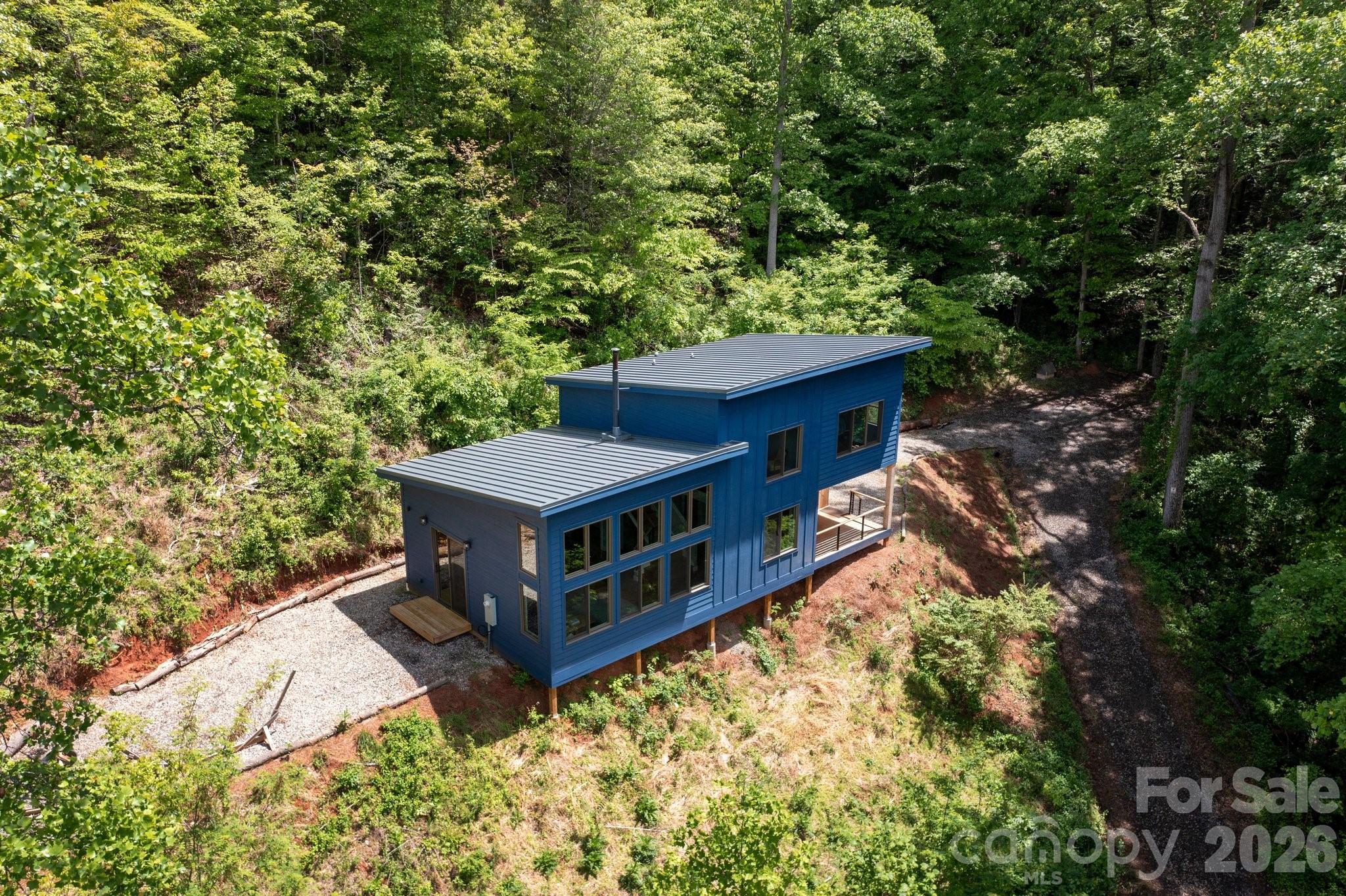 a view of a house with a yard and sitting area