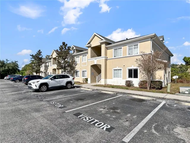 a view of a white car parked in front of a house