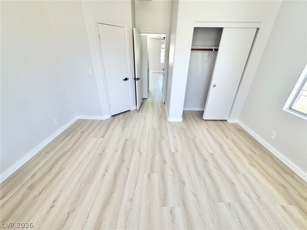 7340 Ridge Star Court Las Vegas, NV 89131 - Photo 11 of 22 Laminate flooring and crisp white walls create a spacious and inviting atmosphere.