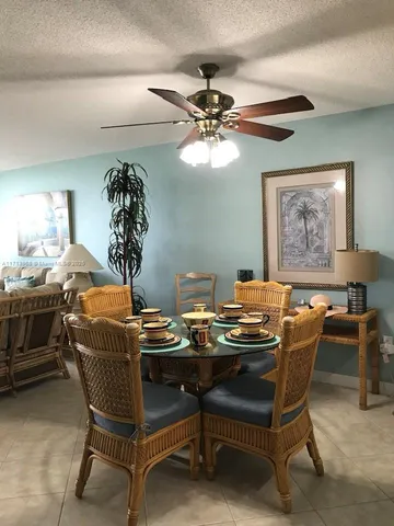 a bedroom with a large bed and a ceiling fan