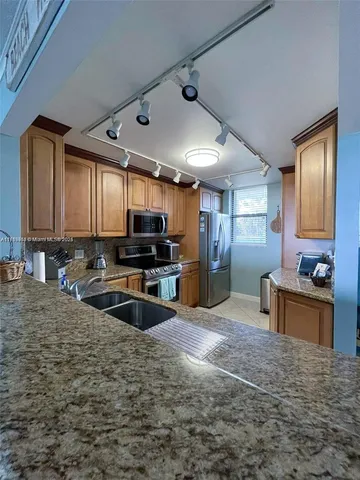 a bedroom with a bed and large windows