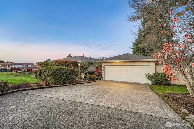 a view of a house with a yard and garage