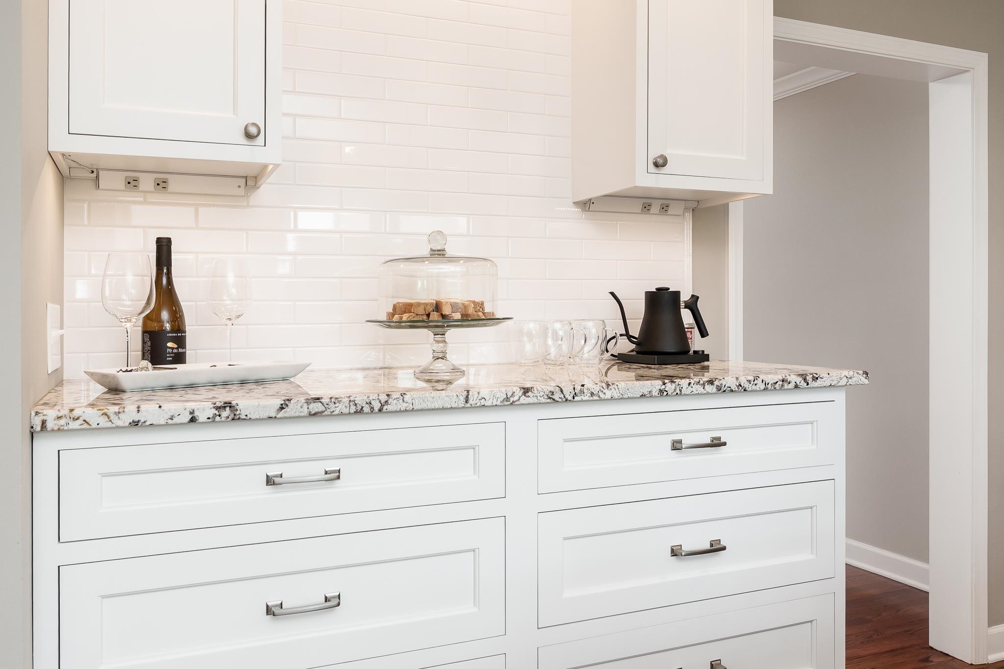 a kitchen with cabinets appliances a sink and dishwasher