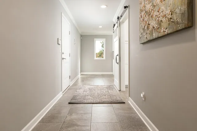 an aerial view of a house with swimming pool and large trees