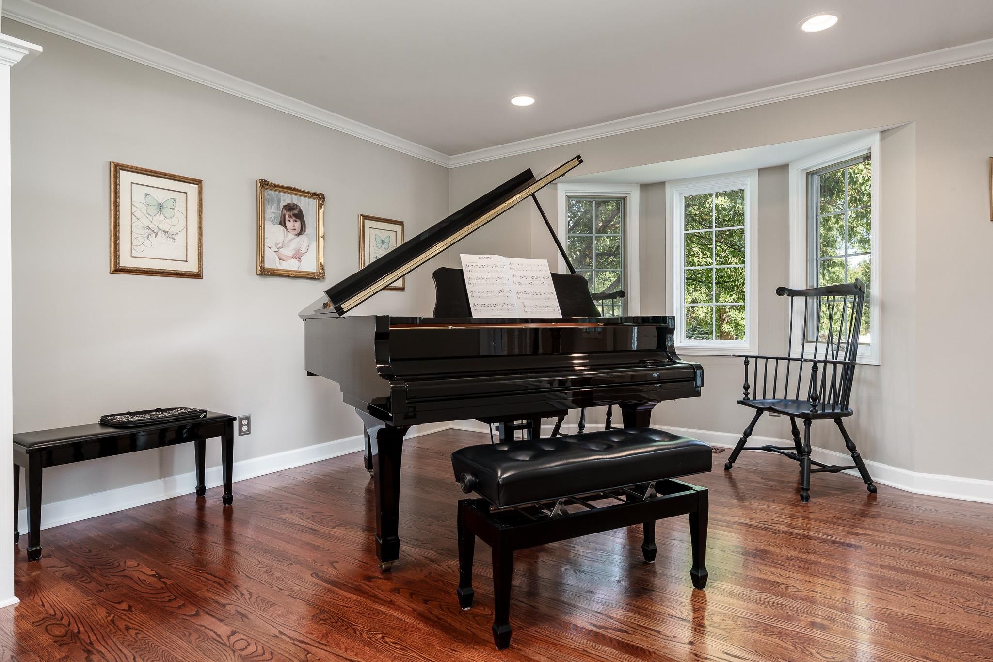 8551 Rote Road Rockford, IL 61107 - Photo 10 of 92 a living room with furniture and a piano next to a large window