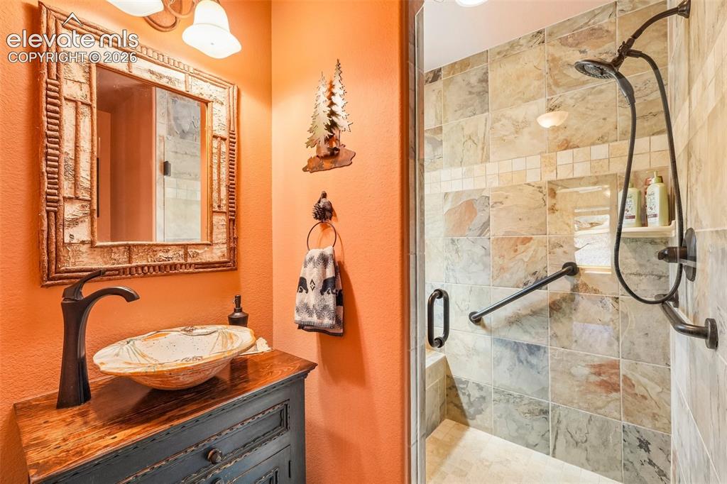858 Oak Ridge Road Manitou Springs, CO 80829 - Photo 8 of 50 3/4 bathroom on main level with custom stand in shower and sink
