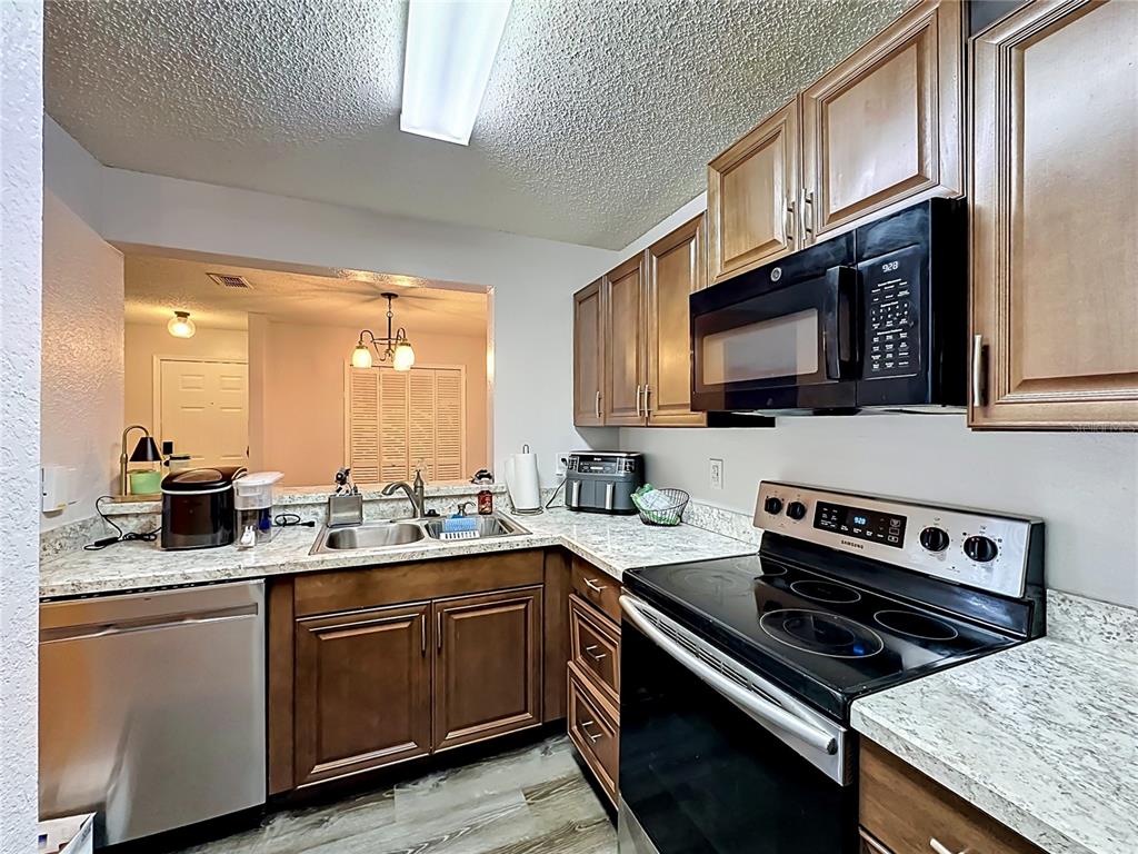 3705 Southwest 27th Street, Unit 922 Gainesville, FL 32608 - Photo 10 of 34 a kitchen with a sink stove top oven and microwave