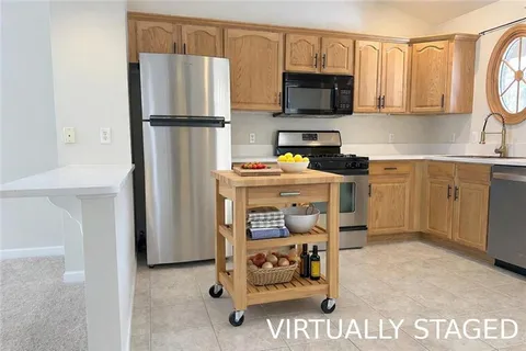 a kitchen with stainless steel appliances granite countertop a refrigerator stove and microwave