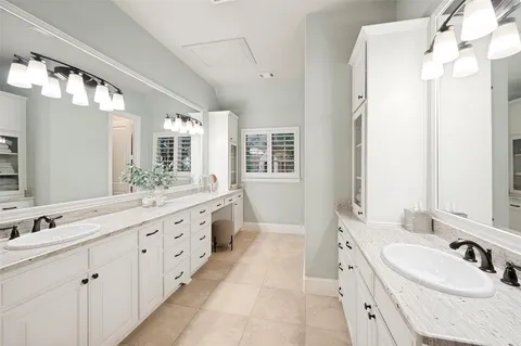 a spacious bathroom with a double vanity sink mirror double and shower