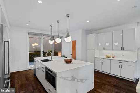 a view of a kitchen with a table and chairs
