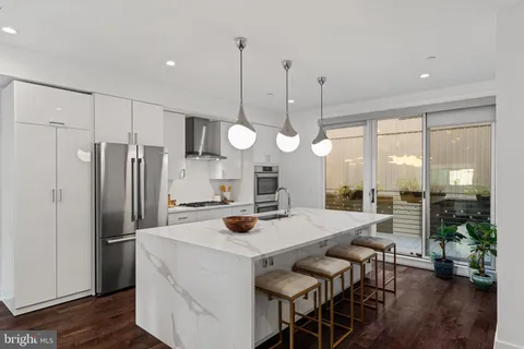 a bathroom with a double vanity sink toilet and shower
