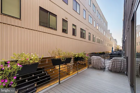 a view of empty room with wooden floor and ceiling fan
