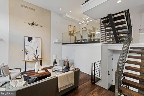 a room with furniture a rug and a wall painting