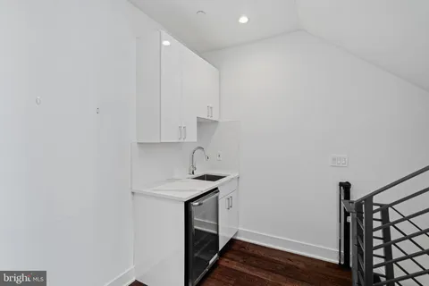 a bathroom with a granite countertop sink a toilet and shower