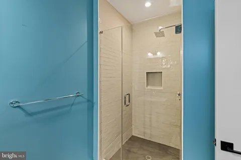 a bedroom with a bed and a ceiling fan