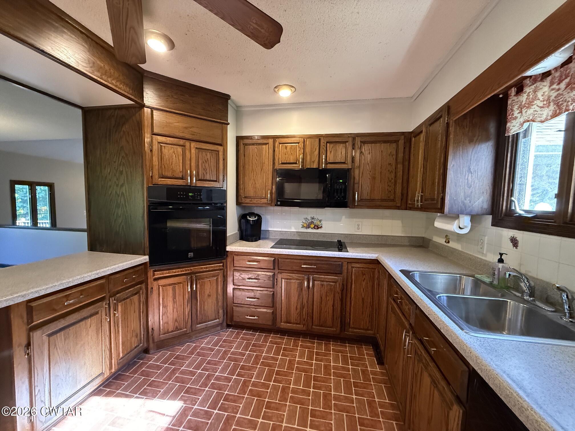 930 Oak Ridge Road Dyersburg, TN 38024 - Photo 24 of 59 a kitchen with stainless steel appliances granite countertop a sink stove and refrigerator