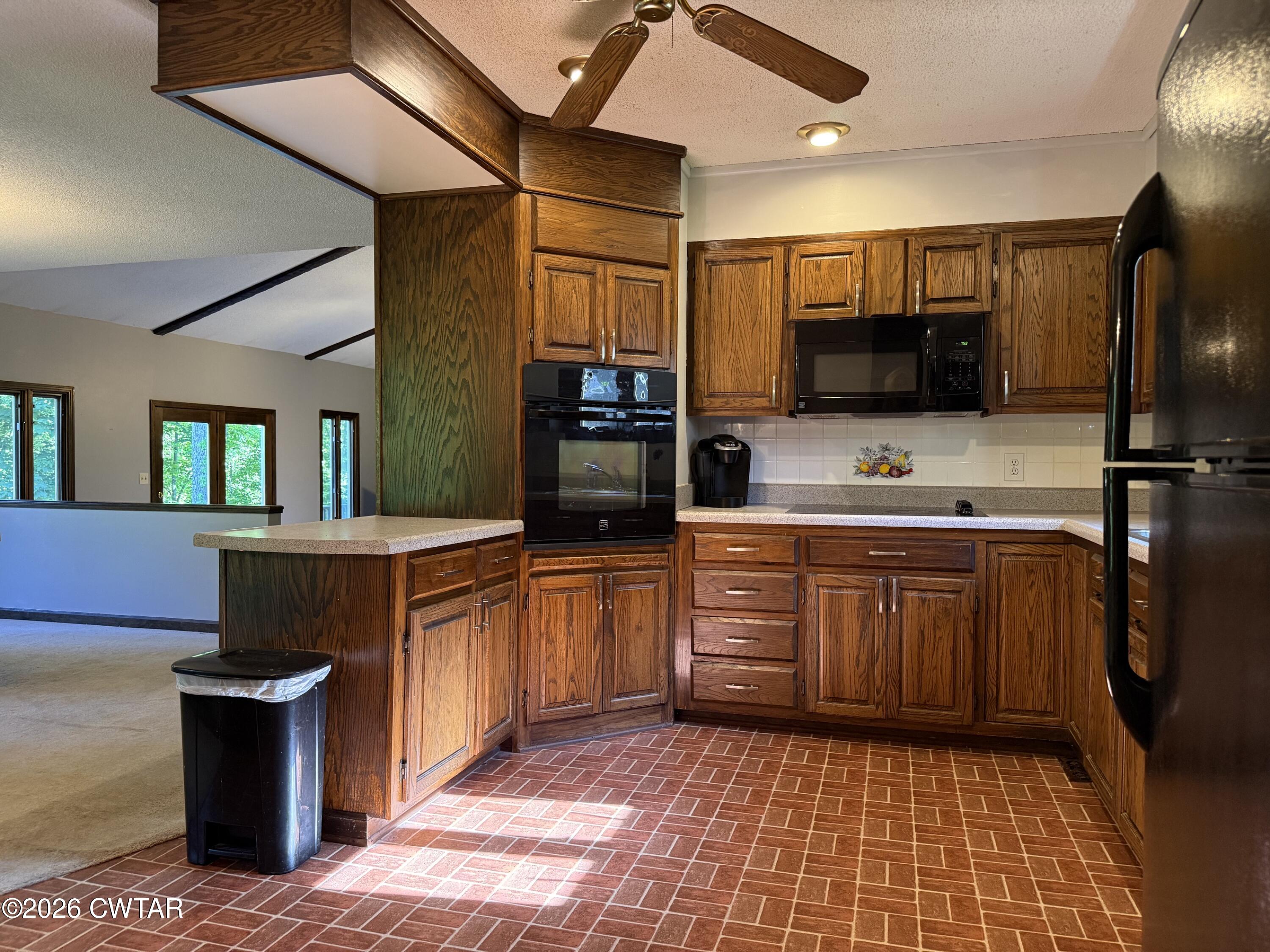 930 Oak Ridge Road Dyersburg, TN 38024 - Photo 25 of 59 a kitchen with stainless steel appliances granite countertop a sink and a refrigerator