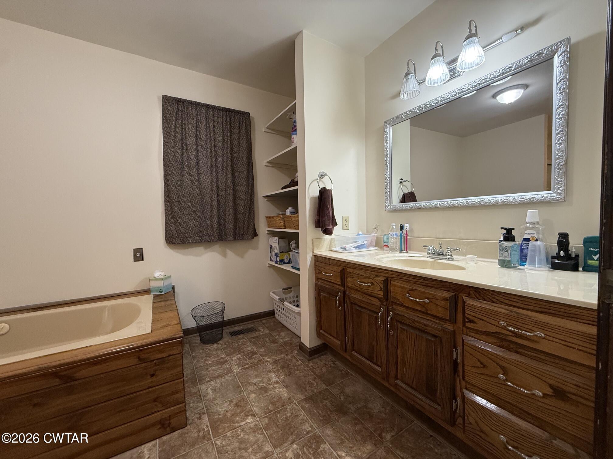 930 Oak Ridge Road Dyersburg, TN 38024 - Photo 33 of 59 a spacious bathroom with a sink double vanity granite and a mirror