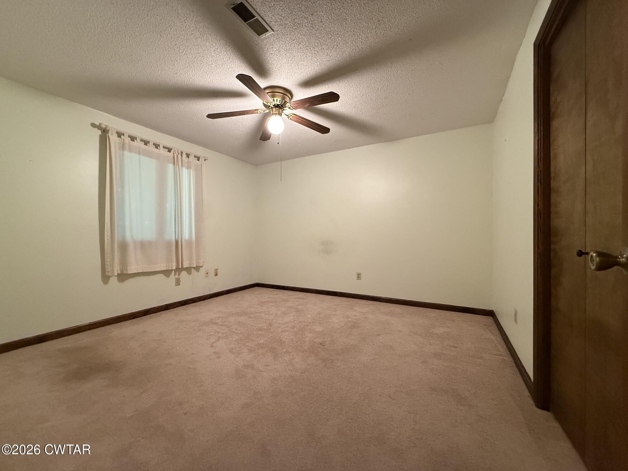 930 Oak Ridge Road Dyersburg, TN 38024 - Photo 37 of 59 an empty room with windows and fan