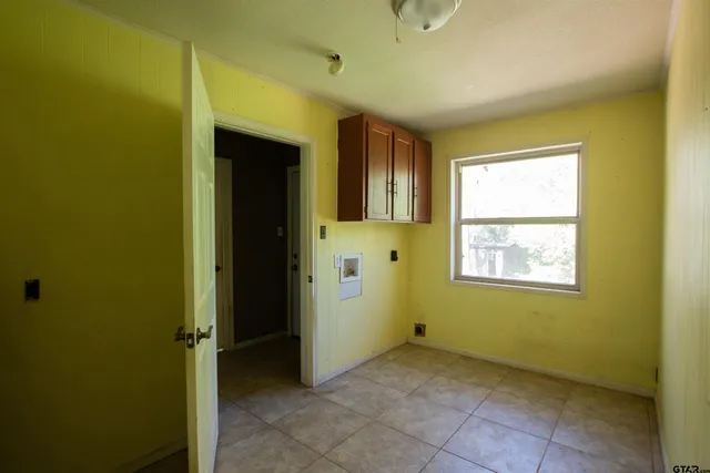 an empty room with windows and closet