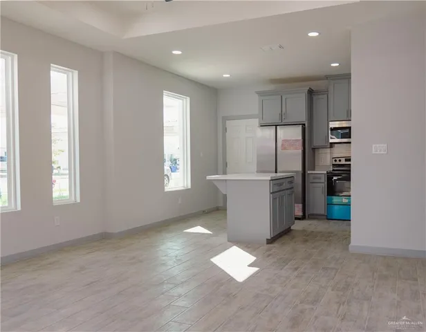 a kitchen with refrigerator and window