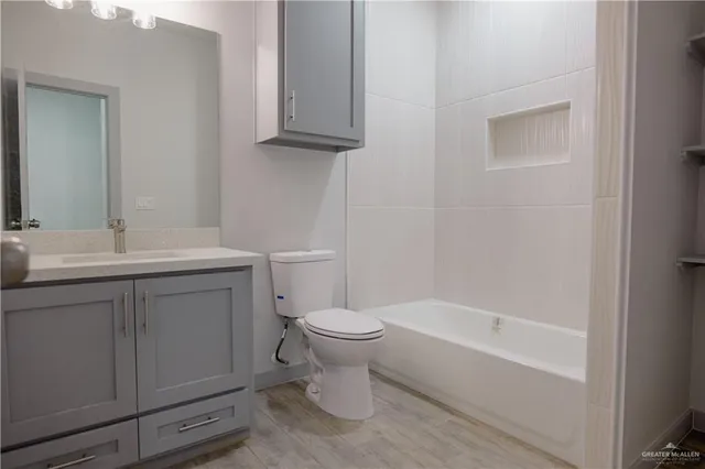 a bathroom with a sink toilet and vanity