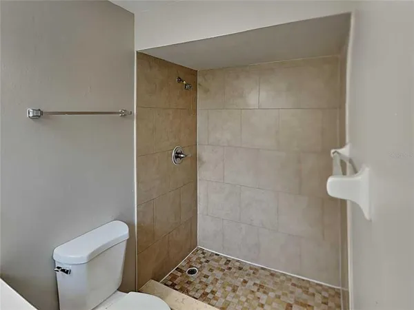 a bathroom with a toilet and shower