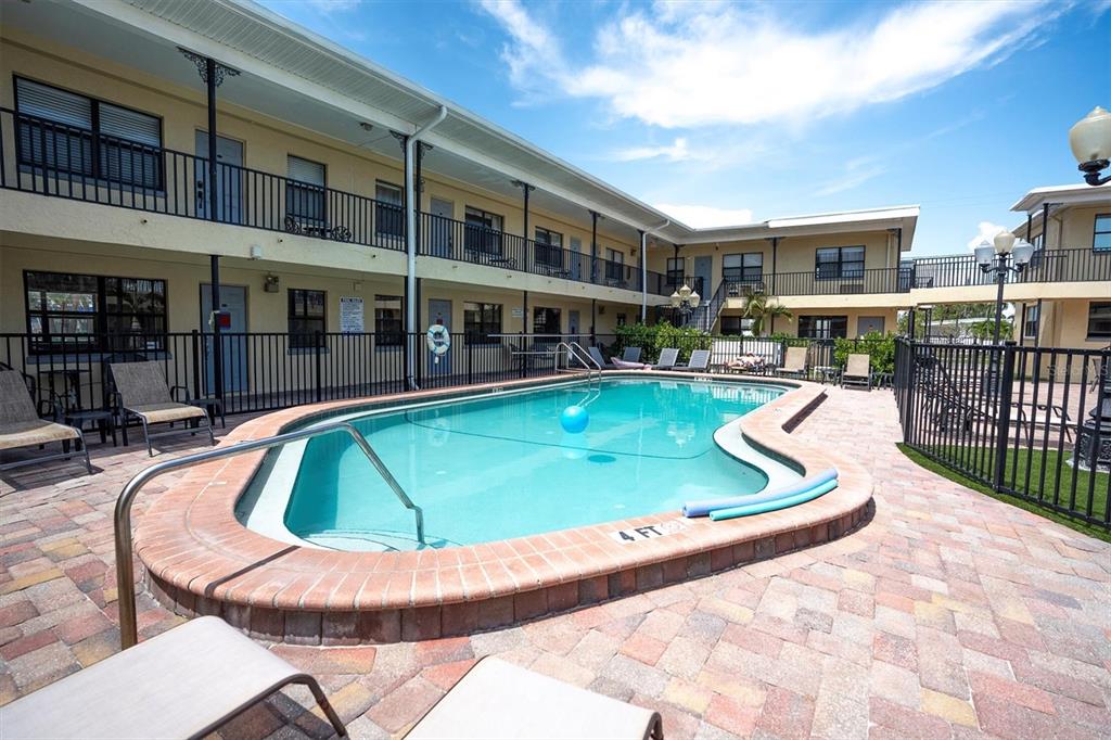 a view of a swimming pool with a lounge chair