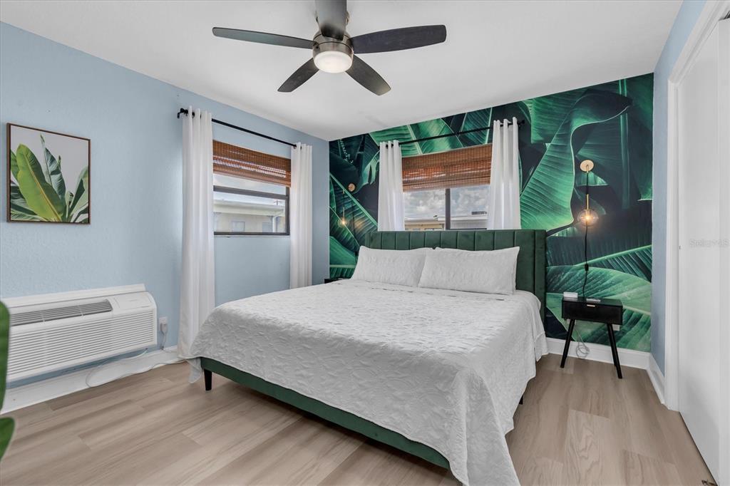16333 Gulf Boulevard, Unit 217 St. Petersburg, FL 33708 - Photo 14 of 30 a bedroom with a bed and a painting on the wall