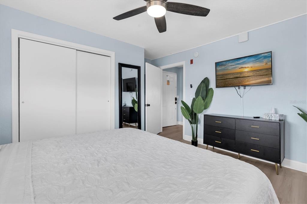 16333 Gulf Boulevard, Unit 217 St. Petersburg, FL 33708 - Photo 15 of 30 a bedroom with a bed and a flat screen tv
