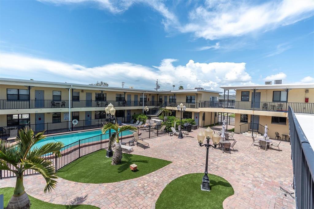 16333 Gulf Boulevard, Unit 217 St. Petersburg, FL 33708 - Photo 19 of 30 a view of a house with backyard sitting area and swimming pool
