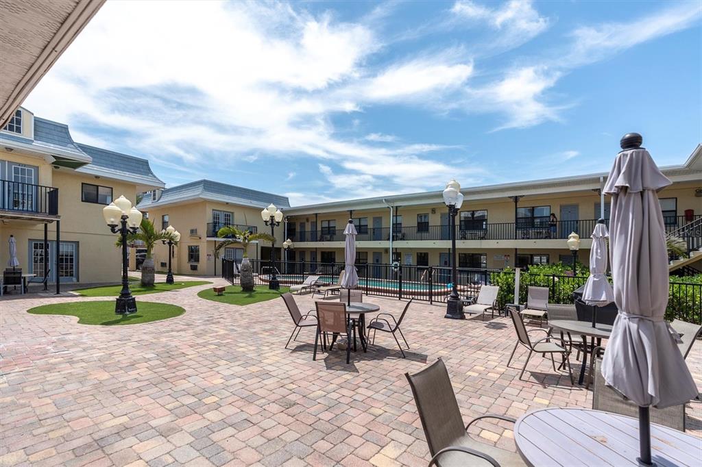 16333 Gulf Boulevard, Unit 217 St. Petersburg, FL 33708 - Photo 20 of 30 a building outdoor space with patio furniture and potted plants
