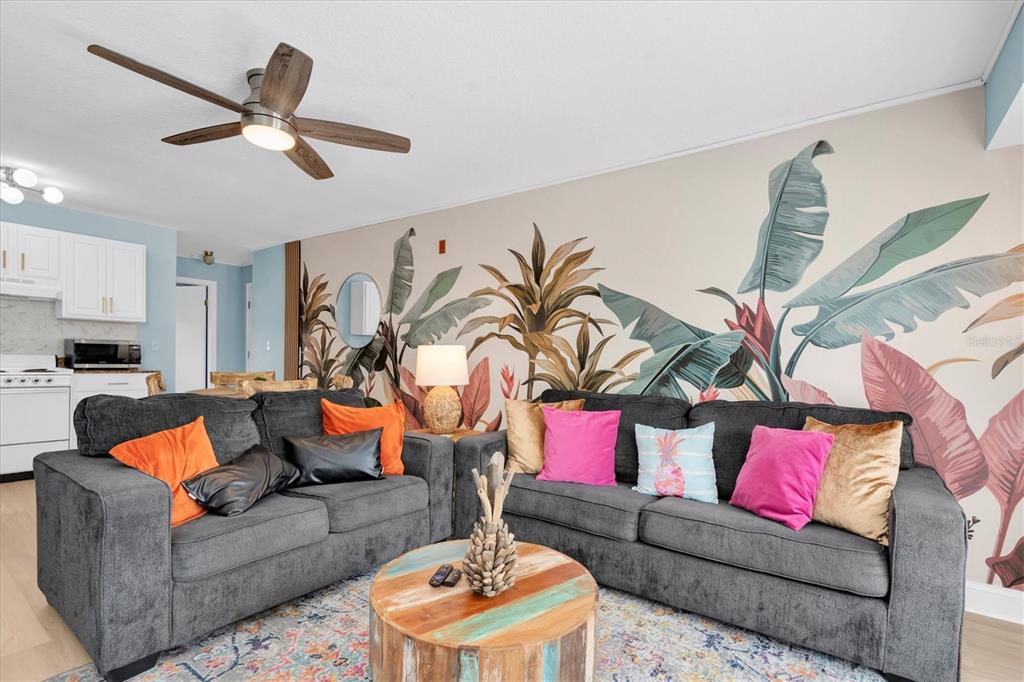 16333 Gulf Boulevard, Unit 217 St. Petersburg, FL 33708 - Photo 4 of 30 a living room with furniture and a ceiling fan