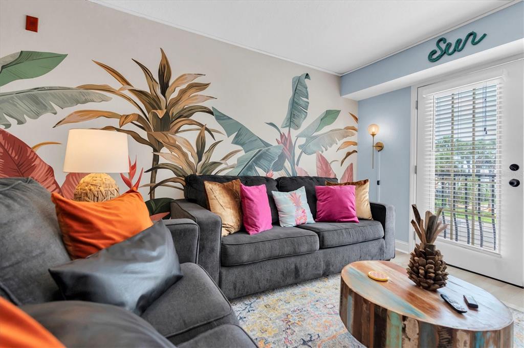 16333 Gulf Boulevard, Unit 217 St. Petersburg, FL 33708 - Photo 6 of 30 a living room with furniture and a potted plant