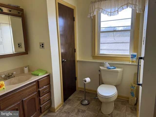 a bathroom with a toilet sink and mirror