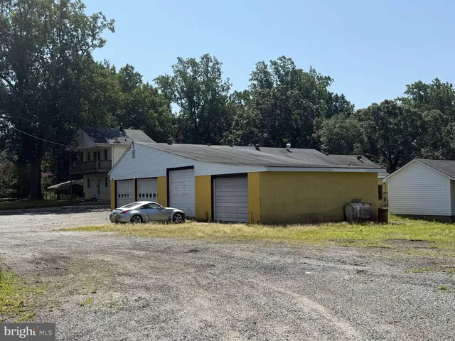 a view of a house with pool and a yard