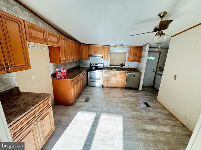 a kitchen with sink refrigerator and microwave