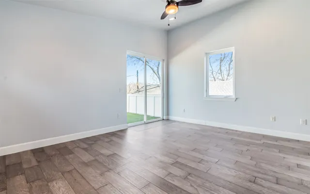 wooden floor in an empty room with a window