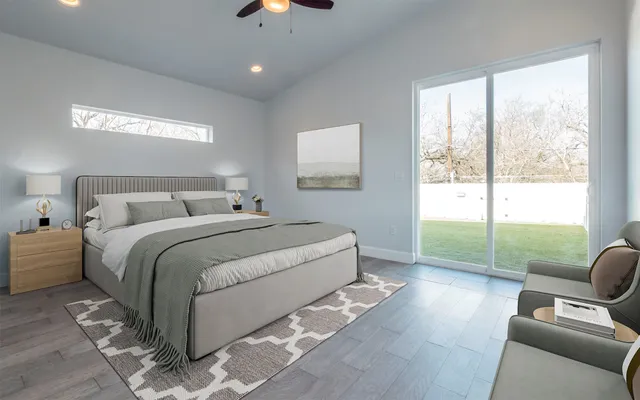 a spacious bedroom with a bed and glass window