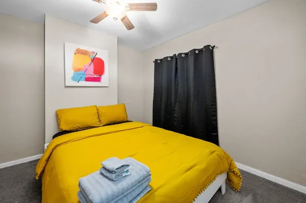 a bedroom with a bed and a dresser