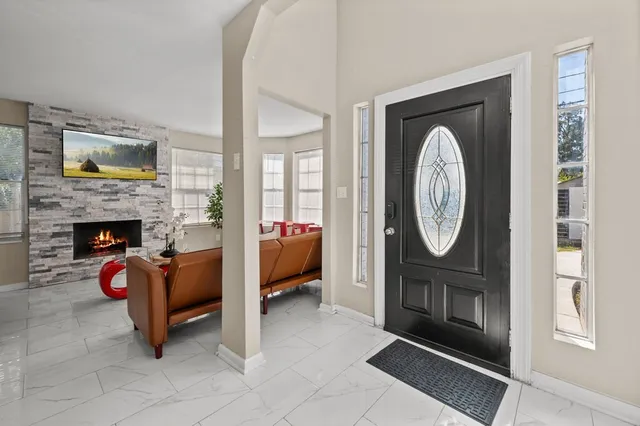 a living room with furniture a mirror and a fireplace