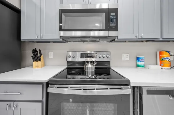 a living room with furniture fireplace and a large window