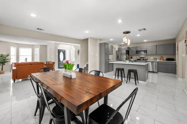 a view of living room kitchen with furniture and a fireplace