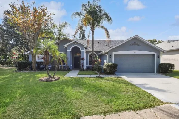 a front view of a house with a yard and garage