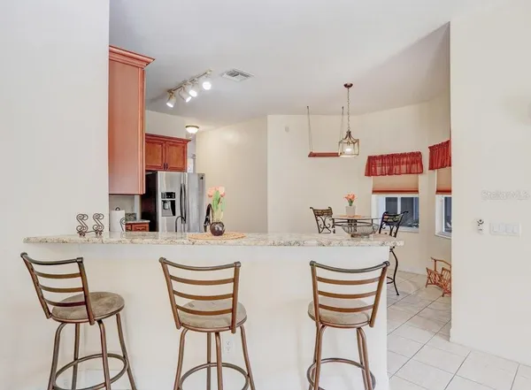 a dining room with furniture and wooden floor