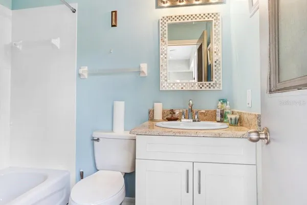 a bathroom with a sink toilet and mirror