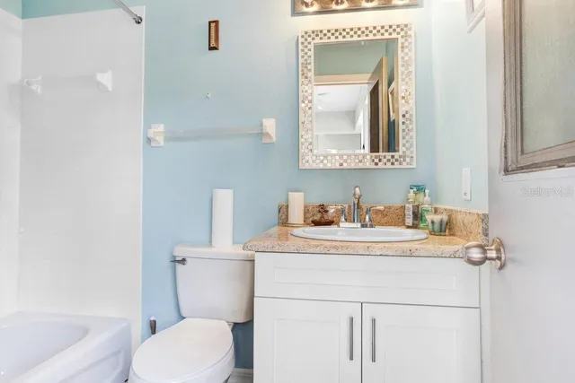 a bathroom with a sink toilet and mirror
