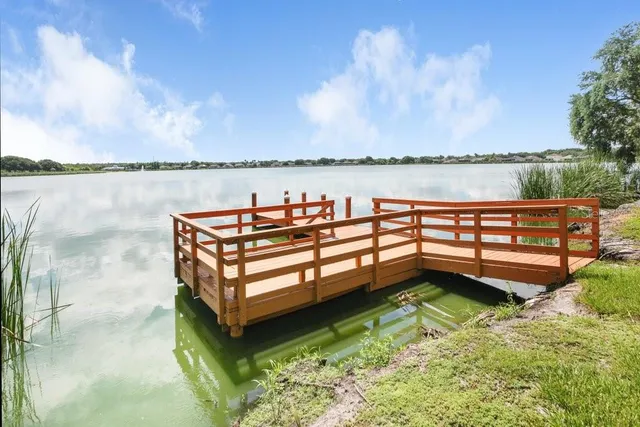 a backyard of a house with lake view and a garden