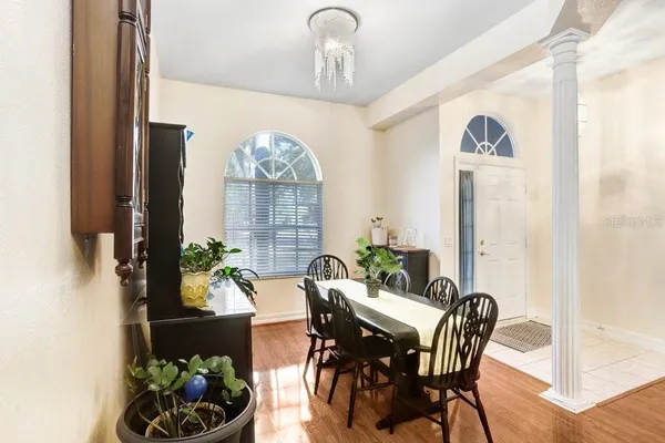 a view of a dining room with furniture and chandelier